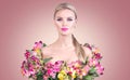 Beauty blonde model girl in summer dress made from colorful fresh flowers. Beautiful spring young romantic woman