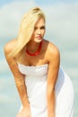 Beauty blonde woman portrait on sky background. Royalty Free Stock Photo
