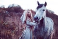 beauty blondie with horse in the field, effect of toning Royalty Free Stock Photo