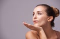 Beauty blowing you a kiss. A gorgeous young woman blowing a kiss in studio.