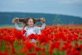 Beauty blue eyes teen enjoy summer days .Cute fancy dressed girl in poppy field. Field of blooming poppies Royalty Free Stock Photo