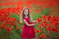 Beauty blue eyes teen enjoy summer days .Cute fancy dressed girl in poppy field. Field of blooming poppies Royalty Free Stock Photo