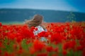 Beauty blue eyes teen enjoy summer days .Cute fancy dressed girl in poppy field. Field of blooming poppies Royalty Free Stock Photo