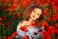 Beauty blue eyes teen enjoy summer days .Cute fancy dressed girl in poppy field. Field of blooming poppies. Royalty Free Stock Photo