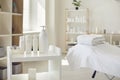 Spa room or beauty salon with set of organic skincare products and empty bed with fresh towels Royalty Free Stock Photo