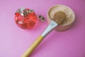 Beauty box, powder with a brown brush from nap for makeup, pink perfume and earrings on a background. Flat lay. Top view Royalty Free Stock Photo