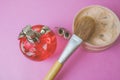 Beauty box, powder with a brown brush from nap for makeup, pink perfume and earrings on a background. Flat lay. Top view Royalty Free Stock Photo