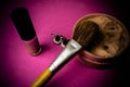 Beauty box, powder with a brown brush from nap for makeup, pink perfume and earrings on a background. Flat lay. Top view Royalty Free Stock Photo