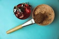 Beauty box, powder with a brown brush from nap for makeup, pink perfume and earrings on a blue background. Flat lay. Top view Royalty Free Stock Photo