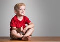 Beauty boy sitting on a table