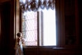 Beauty bride in bridal gown with bouquet and lace veil indoors Royalty Free Stock Photo