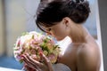 Beauty bride in bridal gown with bouquet and lace veil indoors Royalty Free Stock Photo