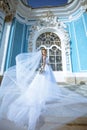 Beauty bride in bridal gown with bouquet and lace veil in the nature Royalty Free Stock Photo