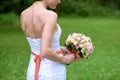 Beauty bride in bridal gown with bouquet and lace veil in the nature Royalty Free Stock Photo