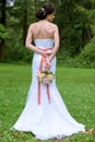 Beauty bride in bridal gown with bouquet and lace veil in the nature Royalty Free Stock Photo