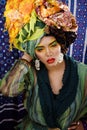 Beauty bright woman with creative make up, many shawls on head like cubian, ethno look closeup Royalty Free Stock Photo