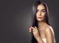 Beauty brunette model girl touching long hair Royalty Free Stock Photo