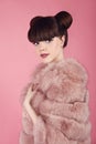 Beauty bun hairstyle. Fashion teen girl model in pink fur coat.