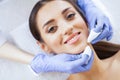 Beauty and Care. Beautiful Young Girl Lying On Massage Tables In Spa Salon. Facial Procedures. Facial Massage. Girl with Royalty Free Stock Photo