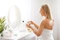 Beauty Care Concept. Smiling Middle Aged Woman Opening Jar With Moisturising Cream Royalty Free Stock Photo