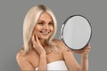 Beauty Care. Portrait Of Smiling Mature Woman Looking In Magnifying Mirror Royalty Free Stock Photo