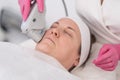 beauty center a female mature client receive ultrasound face lifting with professional equipment.