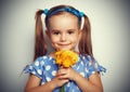 Beauty child girl with a bouquet of yellow flowers