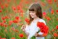 Beauty child portrait at the wild red poppy flowers Royalty Free Stock Photo