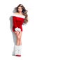 Beauty Christmas fashion model girl, wearing red Santa dress. Sexy brunette young woman with long curly hair Royalty Free Stock Photo