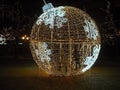 The beauty of Christmas - a glowing Christmas ball through which people pass