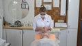 Beauty clinic. Beautician in gloves making face aging injection in a female skin. A woman gets beauty facial cosmetology Royalty Free Stock Photo