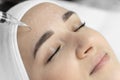 In beauty clinic cosmetologist conducts fractional facial mesotherapy to stimulate natural processes skin renewal and