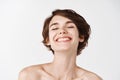 Beauty. Close-up of beautiful and natural girl with white smile and naked shoulders laughing, smiling carefree. Young Royalty Free Stock Photo