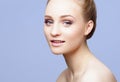 Beauty close-up portrait of beautiful, fresh and healthy girl over blue background. Royalty Free Stock Photo