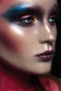 Beauty close-up portrait of beautiful woman model face with magic creative fashion multicolored make-up. Face painting, cosmetics, Royalty Free Stock Photo