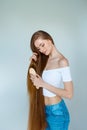 Beauty close-up portrait of beautiful young woman with long brown hair on white background. Hair care concept. Royalty Free Stock Photo