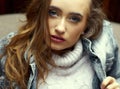 Beauty close up portrait of a young attractive girl with cherry lipstick on her lips dressed with a denim jacket Royalty Free Stock Photo