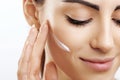 Beauty Closeup happy young woman apply cream to her face Skincare and cosmetics concept. Cosmetics. Woman face skin care.Natural Royalty Free Stock Photo