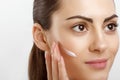 Beauty Closeup happy young woman apply cream to her face Skincare and cosmetics concept. Cosmetics. Woman face skin care.Natural Royalty Free Stock Photo