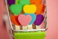 Beauty Colorful mini hearts with other color blur pink and white background and copy space in the mini shopping cart Royalty Free Stock Photo