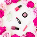 Beauty composition with pink flowers and make up cosmetics with aroma on white background. Top view. Flat lay feminine desk Royalty Free Stock Photo