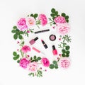 Beauty composition with pink flowers and make up cosmetics on white background. Top view. Flat lay feminine desk Royalty Free Stock Photo