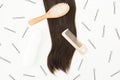 Beauty composition. Tools for hairdresser with shampoo and hairs on white background. Flat lay, top view