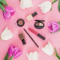 Beauty composition with tulips flowers and cosmetics - lipstick, nail polish on pink background. Top view. Flat lay. Home feminine Royalty Free Stock Photo