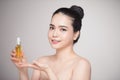 Beauty concept. Asian pretty woman with perfect skin holding oil Royalty Free Stock Photo