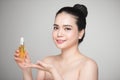 Beauty concept. Asian pretty woman with perfect skin holding oil Royalty Free Stock Photo