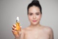 Beauty concept. Asian pretty woman with perfect skin holding oil Royalty Free Stock Photo