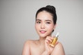 Beauty concept. Asian pretty woman with perfect skin holding oil Royalty Free Stock Photo