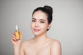 Beauty concept. Asian pretty woman with perfect skin holding oil Royalty Free Stock Photo