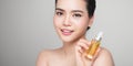 Beauty concept. Asian pretty woman with perfect skin holding oil bottle Royalty Free Stock Photo